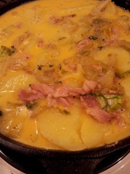 When the egg has started to set but there is still some liquid on top, that is when you add cheese and herbs and place under the grill.