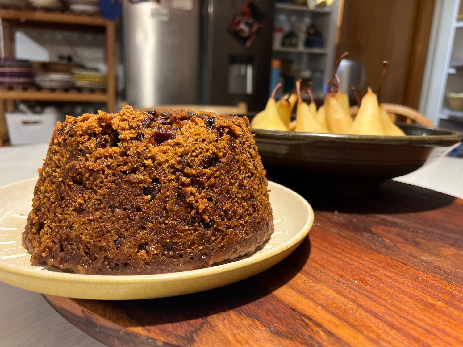 Overnight steamed pudding accompanied by poached pears